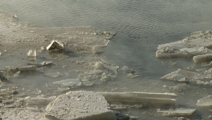 Broken ice marks where a vehicle impacted the South Saskatchewan River after going over the Circle Drive North Bridge on Dec. 30, 2013.