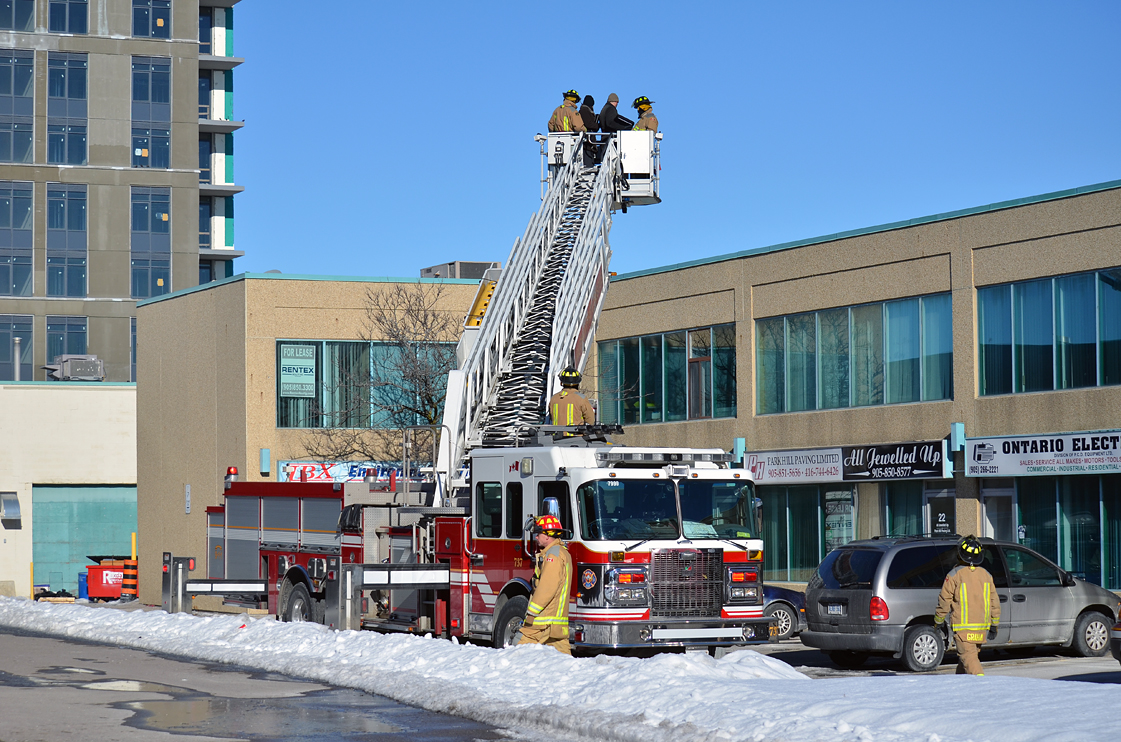 Fire and police officials investigate after a man was found dead atop a Woodbridge plaza. December 30, 2013.