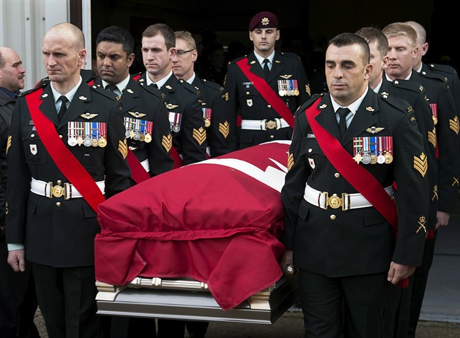 Members of The Royal Canadian Regiment carry the casket at the funeral for Warrant Office Michael Robert McNeil at the Truro Armouries in Truro, N.S. on Thursday, Dec. 5, 2013. McNeil completed several tours of duty including Afghanistan, Bosnia and Croatia. McNeil took his own life late last month at CFB Petawawa. THE CANADIAN PRESS/Andrew Vaughan.