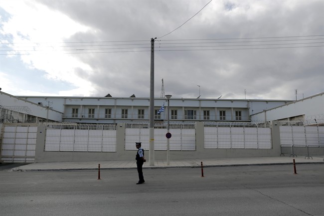 In this Oct. 3, 2013 photo, a policeman stands outside Korydallos Judicial Prison, west of Athens.