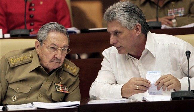 Incoming Cuban president Miguel Diaz-Canel, right, is seen in this 2013 file photo with Raul Castro.