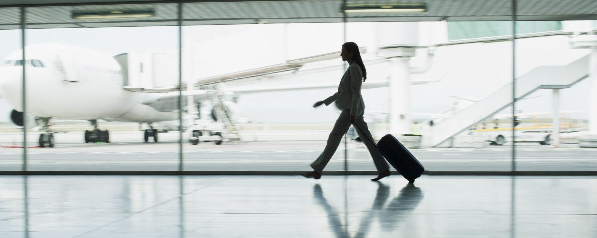 Businesswoman with suitcase in airport