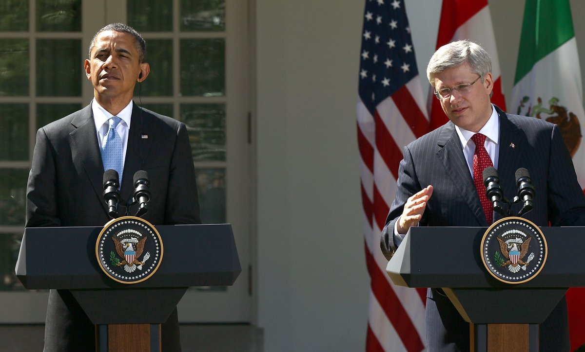 Canadian Prime Minister Stephen Harper (R) answers a question during a joint press conference with U.S. President Barack Obama (L) and Mexican President Felipe Calderon in the Rose Garden of the White House April 2, 2012 in Washington, DC.