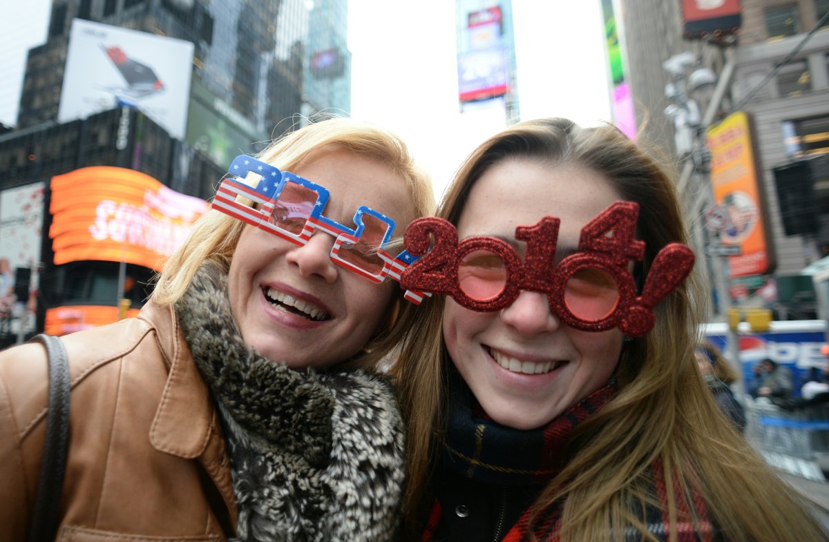 Revelers prepare to watch the New Year ball drop on December 31, 2013 in Times Square in New York. The crowd is expected to reach one million for the event.  (DON EMMERT/AFP/Getty Images).