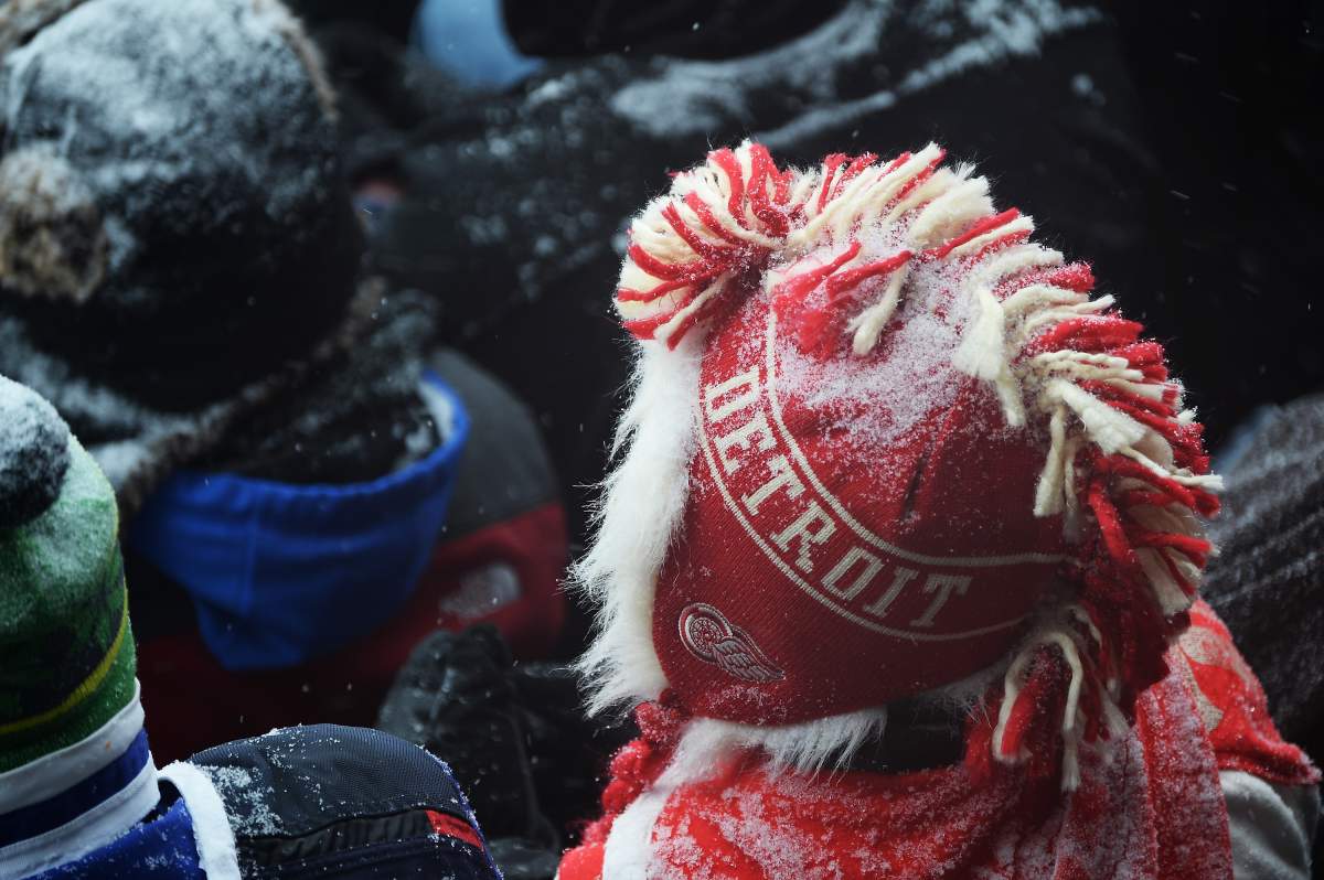 ANN ARBOR, MI - JANUARY 1: A Detroit Red Wings fan watches the Red Wings play against the Toronto Maple Leafs during the 2014 Bridgestone NHL Winter Classic on January 1, 2014 at Michigan Stadium in Ann Arbor, Michigan. (Photo by Jamie Sabau/Getty Images)