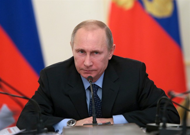 Russian President Vladimir Putin chairs a meeting with officials focusing on economy in the Novo-Ogaryovo residence outside Moscow, Russia, Thursday, Jan. 30, 2014. (AP Photo/RIA-Novosti, Mikhail Metzel, Presidential Press Service).