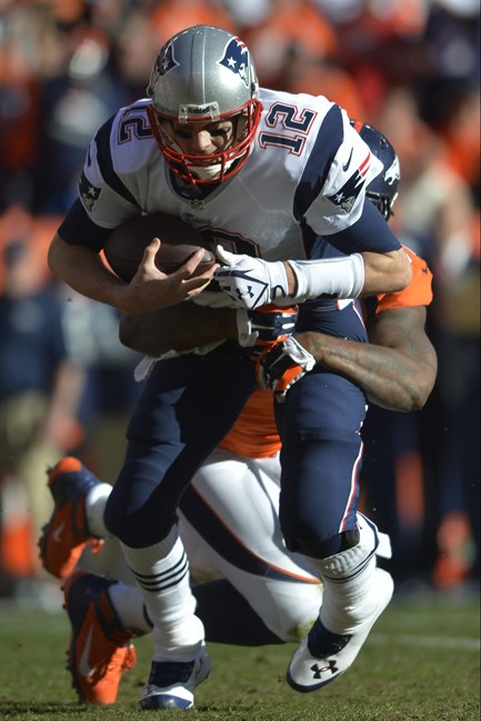 New England Patriots quarterback Tom Brady (12) is sacked by Denver Broncos defensive end Robert Ayers (91) during the first half of the AFC Championship NFL playoff football game in Denver, Sunday, Jan. 19, 2014. 