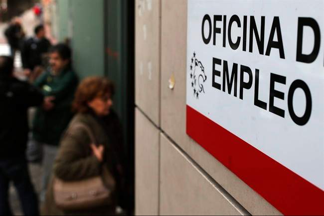 People enter an unemployment registry office in Madrid, Spain, Friday, Jan. 3, 2014.