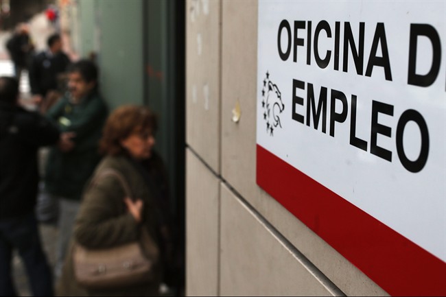 People enter an unemployment registry office in Madrid, Spain, Friday, Jan. 3, 2014.