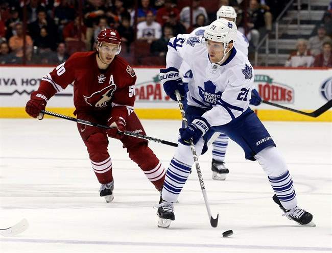 Toronto Maple Leafs left wing James van Riemsdyk (21) carries the puck past Phoenix Coyotes center Antoine Vermette (50) in the first period of an NHL hockey game, Monday, Jan. 20, 2014, in Glendale, Ariz.