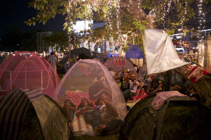 Anti-government protesters listen to political speeches as they occupy the victory monument in central Bangkok as part of the 'shutdown Bangkok' effort.