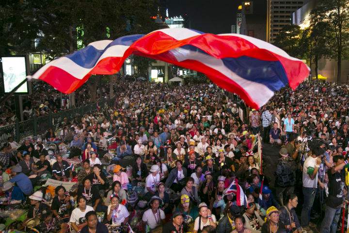 Thai flag flies during an anti-government protest occupying a major intersection in downtown Bangkok.