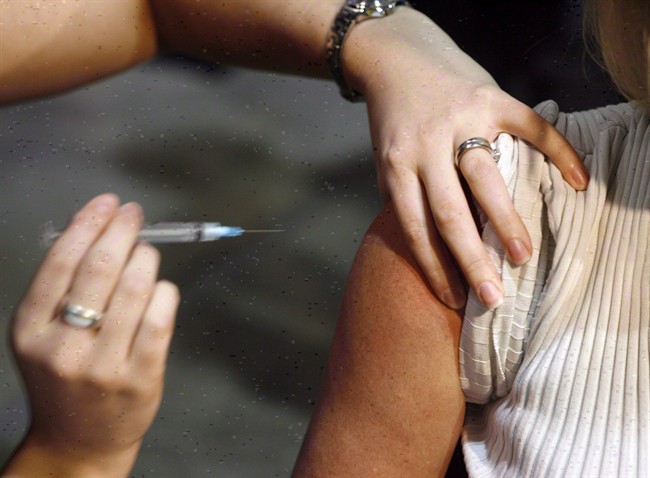 A patient gets a shot during a flu vaccine.