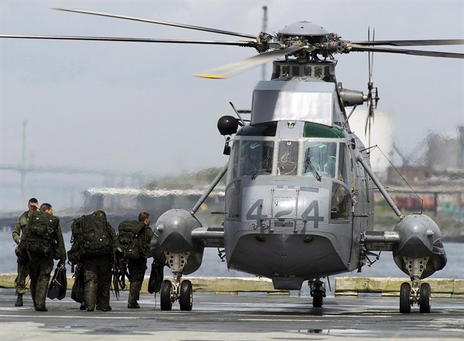 Canadian soldiers board a Sea King helicopter as they participate in advanced amphibious training from the Shearwater Jetty in Halifax on Tuesday, July 30, 2013. The federal government has decided not to scrap its troubled purchase of CH-148 Cyclone helicopters.