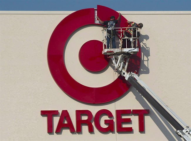 Workers installing an outdoor sign at a then-new Target store in Nova Scotia in mid-2013. The retailer shut down all 133 of its stores this spring, affecting 17,600 employees.