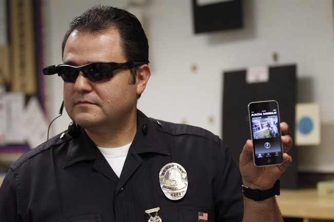 Los Angeles Police Sgt. Daniel Gomez demonstrates a video feed from his camera into his cellphone as on-body cameras are demonstrated for the media.