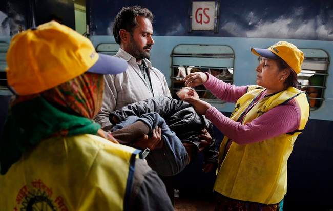 An Indian medical volunteer administers polio immunization drops to a child at a railway station in Allahabad, India, Monday, Jan. 13, 2014. 