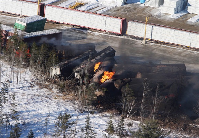 Derailed train cars burn in Plaster Rock, N.B., Wednesday, Jan.8, 2014.
