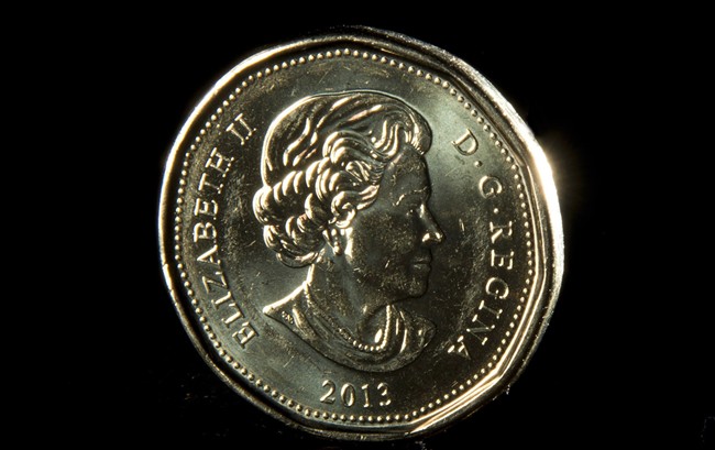 The Canadian dollar strengthened a touch Wednesday, arresting a fast decline in 2014 amid global doubts about the domestic economy.