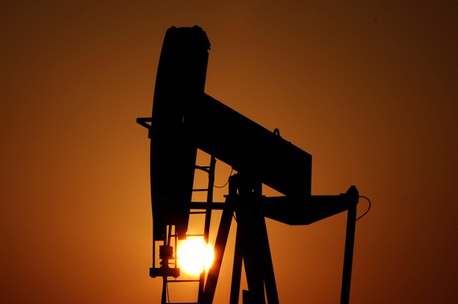 An oil pump works at sunset in the desert oil fields of Sakhir, Bahrain, Jan. 22, 2013.