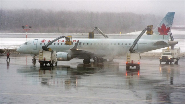 An Air Canada jet is de-iced at Halifax Stanfield International Airport on Dec. 22, 2013.