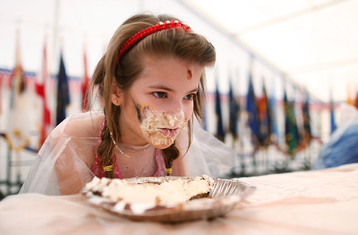 A young girl takes part in a cake eating contest during the Fourth of July festivities at the Baumholder U.S. military base on July 4, 2012 in Baumholder, Germany.