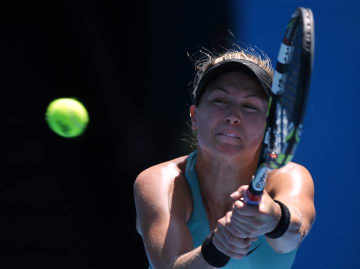 Eugenie Bouchard makes a backhand return to Li Na of China during their semifinal at the Australian Open tennis championship in Melbourne, Australia, Thursday, Jan. 23, 2014.