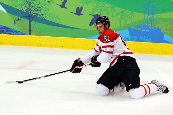Ryan Getzlaf #51 of Canada reaches for the puck during the ice hockey men's semifinal game between Canada and Slovakia on day 15 of the Vancouver 2010 Winter Olympics at Canada Hockey Place on February 26, 2010 in Vancouver.