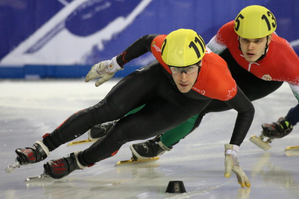 Michael Gilday of Canada(L) and Viktor Knoch of Hungary compete in men's 500m Heat 5 at the 2013 ISU Short Track Speed Skating World Championships, on March 9, 2013 in Debrecen, Hungary.