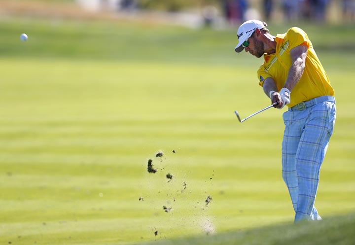 Graham DeLaet hits a shot on the 18th fairway during the final round of The Barclays golf tournament Sunday, Aug. 25, 2013, in Jersey City, N.J., (AP Photo/Rich Schultz)