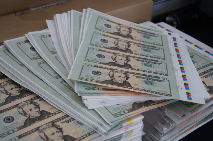File image of counterfeit US cash seized by RCMP in Quebec in January, 2014.