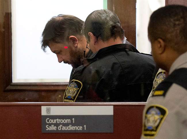 Christopher Fattore is escorted at provincial court in Halifax on Wednesday, Jan. 29, 2014. Fattore, 36, and his common-law spouse, Melissa Merritt, 33, face first-degree murder charges in the death of her ex-husband and his mother in a Toronto-area home. 