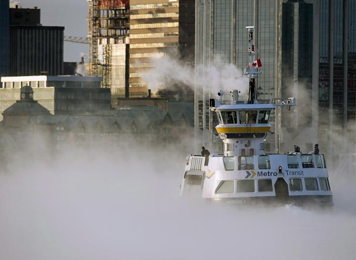 A Metro Transit ferry crosses the harbour through sea smoke, formed when very cold air moves over warm water, in Halifax on Thursday, Jan. 2, 2014.