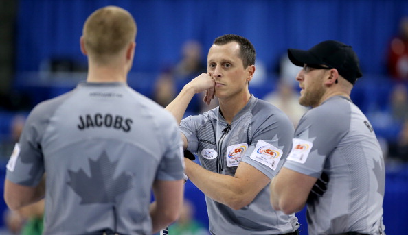 Skip Brad Jacobs talks to Second E.J. Harnden and Lead Ryan Harnden during the Men's Final against Team Morris at the Roar of the Rings Canadian Olympic Curling Trials on December 8, 2013 at MTS Centre in Winnipeg, Manitoba.