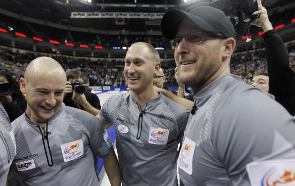 Third Ryan Fry, Skip Brad Jacobs  and Lead Ryan Harnden celebrate after winning the Men's Final against Team Morris at the Roar of the Rings Canadian Olympic Curling Trials on December 8, 2013 at MTS Centre in Winnipeg, Manitoba.