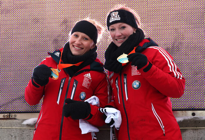 Kaillie Humphries and Heather Moyse of Canada pose with the gold medal after winning the Women's Bobsleigh at the Viessmann FIBT Bob & Skeleton World Cup at the Olympia Bob Run on January 11, 2014 in St Moritz, Switzerland.