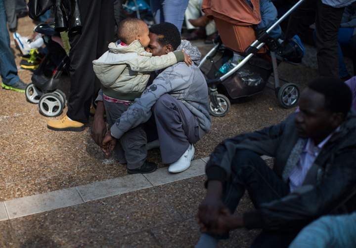 A man hugs his son as tens of thousands of African migrants take part in a rally on Jan. 5, 2014 in Tel Aviv, Israel. The tens of thousands of African migrants held a protest against a law allowing authorities to keep them in open-ended detention until the resolution of their asylum requests are granted or they are deported or volunteered to leave the country. (Photo credit: Getty Images). READ THE STORY HERE.