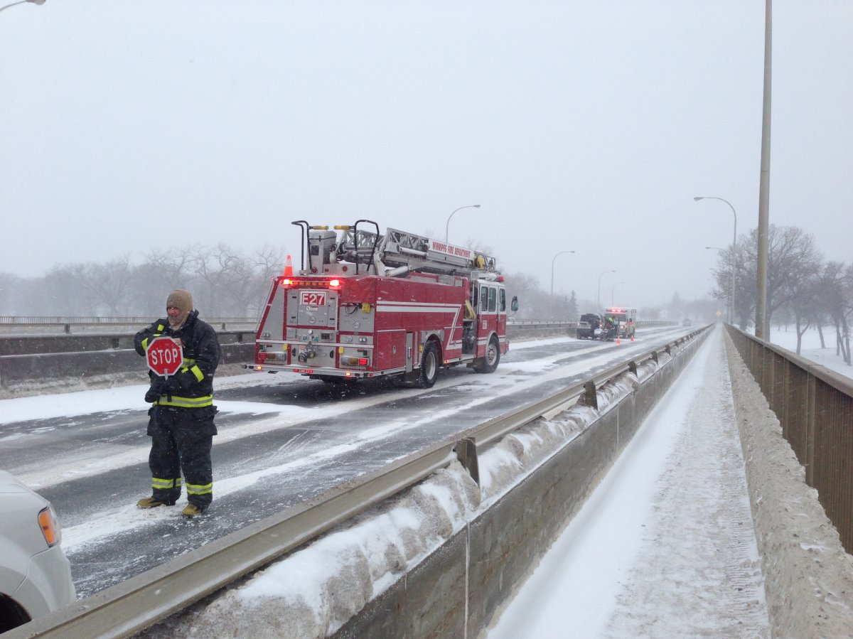 Fire crews respond to a crash on the St. Vital bridge during winter weather in Winnipeg on Wednesday, Jan. 15, 2014.