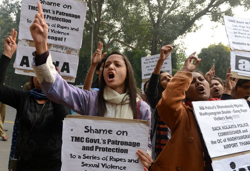 University students from All India Students Association (AISA) and All India Progressive Women Association (AIPWA) shout anti-government slogans during a protest in New Delhi on January 4, 2014, after an Indian teenager was gang-raped in two separate attacks and then died after being set on fire in the eastern city of Kolkata.  