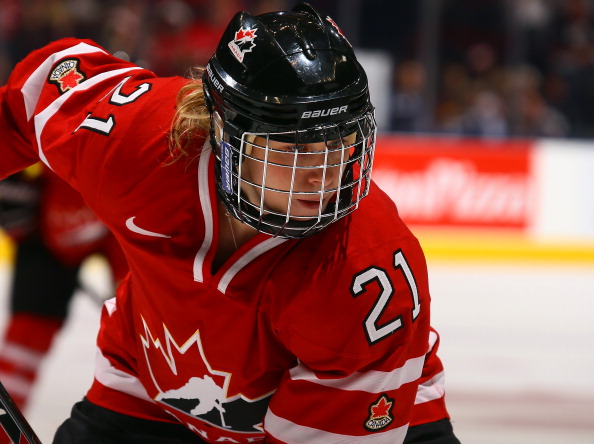 Haley Irwin #21 of Team Canada takes a face-off against Team USA during a Sochi preparation game at the Air Canada Centre December 30, 2013 in Toronto.