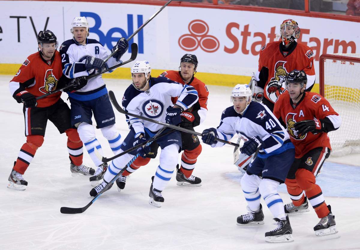 The Ottawa Senators' Craig Anderson tries to keep his eye on the puck as teammates Milan Michalek, left to right, Joe Corvo and Chris Phillips defend against the Winnipeg Jets' Olli Jokinen, left to right, Chris Thorburn, and Devin Setoguchi in Ottawa on Thursday.