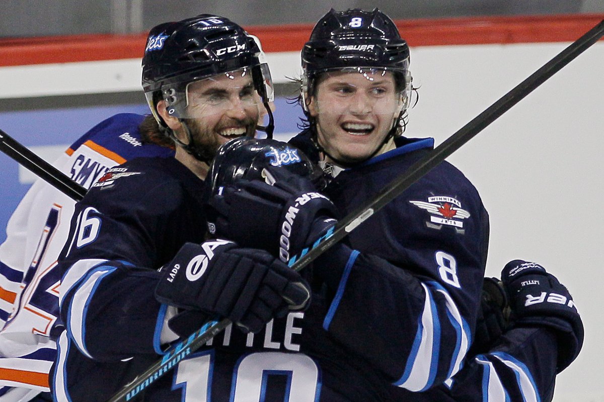 Winnipeg Jets' Andrew Ladd (16), Bryan Little (18) and Jacob Trouba (8) celebrate Trouba's first goal of the game against the Edmonton Oilers in Winnipeg on Saturday.