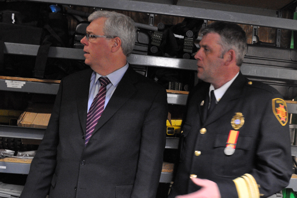 Former Manitoba Fire Commissioner Christopher Jones, right, shown with Manitoba Premier Greg Selinger in file photo.