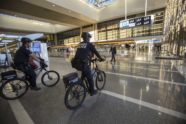 FILE - In this Nov. 2, 2013 file photo, airport police officers patrol the Tom Bradley International Terminal at the Los Angeles International Airport. 
