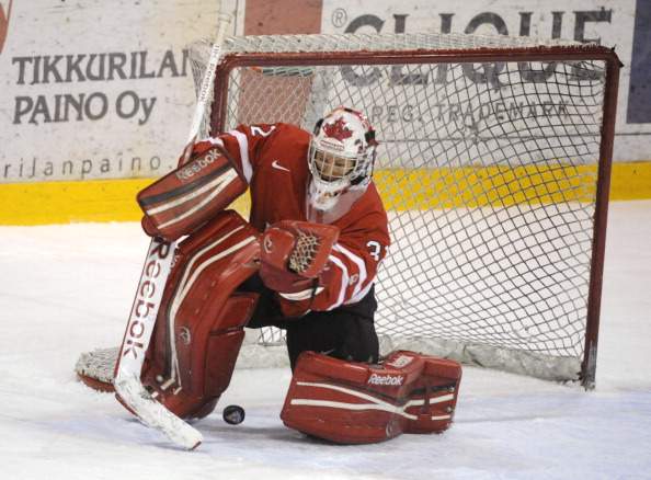 The puck drops between the legs of goalkeeper Charline Labonte of Canada during women's Four Nations tournament gold medal match Canada vs USA in Vantaa, Finland, on November 10, 2012.  