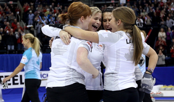  Lead Dawn McEwen, Skip Jennifer Jones, Second Jill Officer and Third Kaitlyn Lawes celebrate after winning the Women's Final against Team Middaugh at the Roar of the Rings Canadian Olympic Curling Trials on December 7, 2013 at MTS Centre in Winnipeg,.