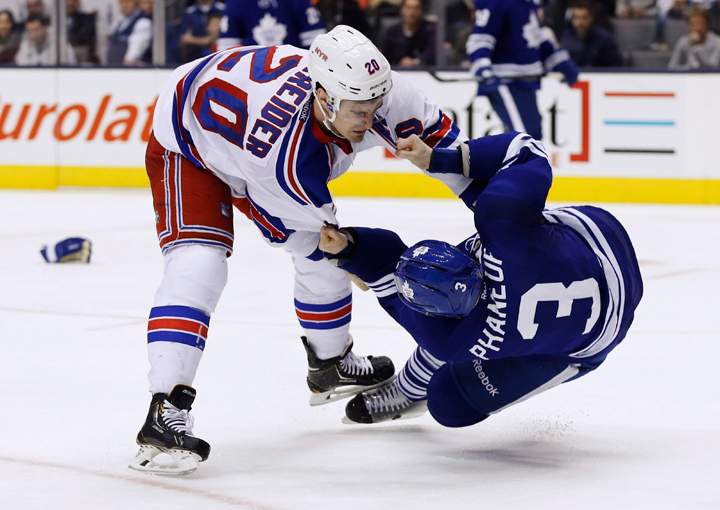 New York Rangers' Chris Kreider, left, takes Toronto Maple Leafs' Dion Phaneuf to the ice in a fight during third period NHL hockey action in Toronto, Saturday January 4, 2014. 