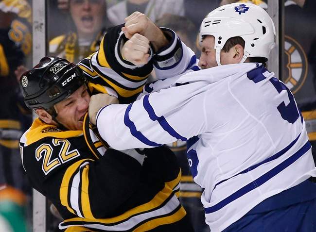Boston Bruins right wing Shawn Thornton (22) fights with Toronto Maple Leafs left wing Frazer McLaren, right, in the first period of an NHL hockey game in Boston, Tuesday, Jan. 14, 2014. (AP Photo/Elise Amendola).