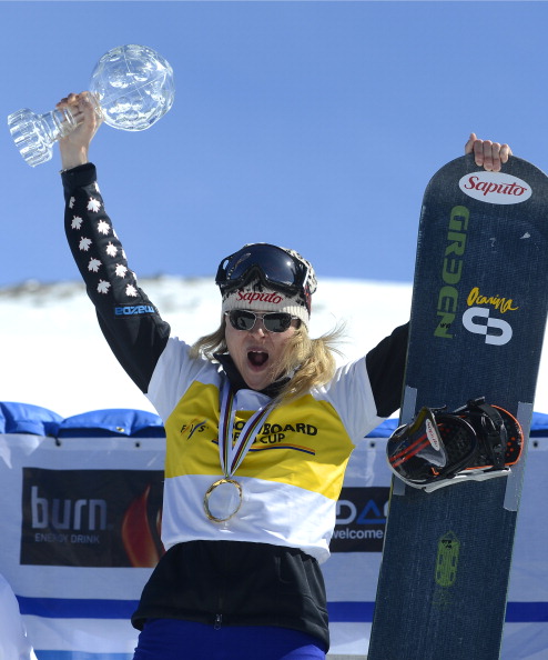 Canadian snowboarder Dominique Maltais lifts the trophy on the podium of the Ladies' overall Snowboard Cross competition during the Snowboard and FreeStyle World Cup at Sierra Nevada ski resort near Granada on March 21, 2013.