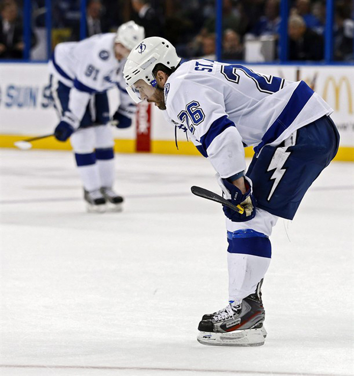 Tampa Bay Lightning's Martin St. Louis, right, and Steven Stamkos take a breather after the end of the third period of an NHL hockey game against the Carolina Hurricanes Sunday, April 21, 2013, in Tampa, Fla. Stamkos made the Canadian Olympic hockey team but Tampa Bay teammate Martin St. Louis was passed over, and coach Jon Cooper says he knows how disappointed the veteran was by the decision.